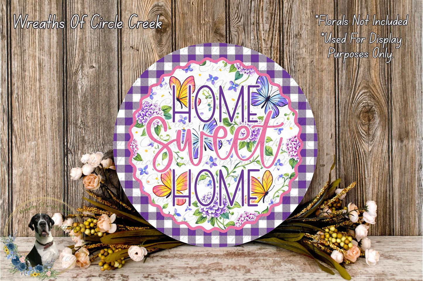 a decorative sign with the text "Home Sweet Home" surrounded by a floral arrangement and a wooden background.