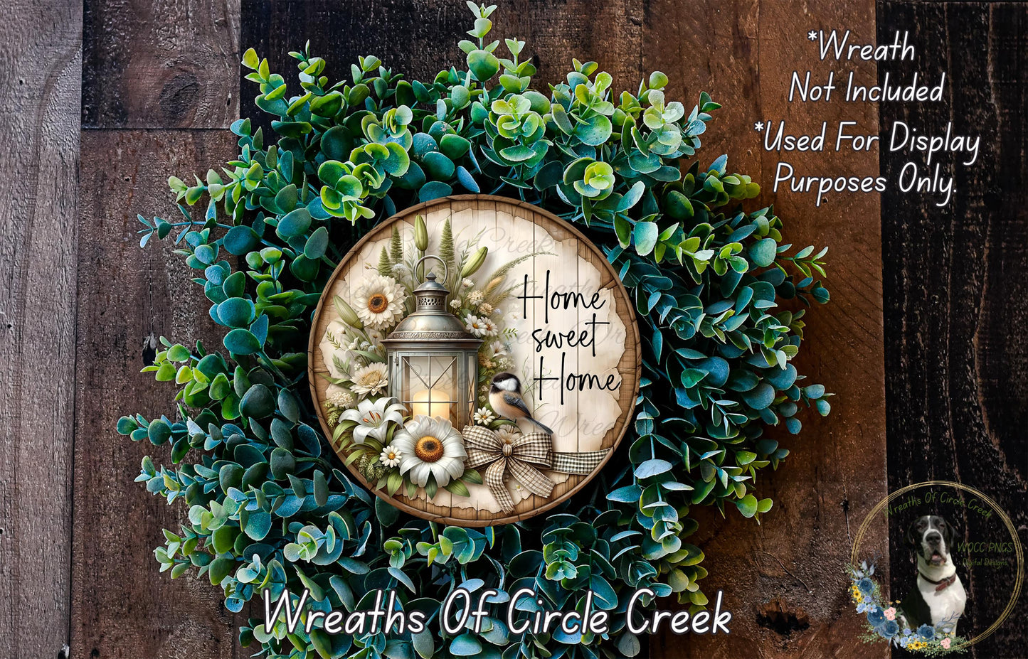 a wreath with a lantern and flowers, surrounded by greenery, and a wooden sign with the text "Home Sweet Home" on it.