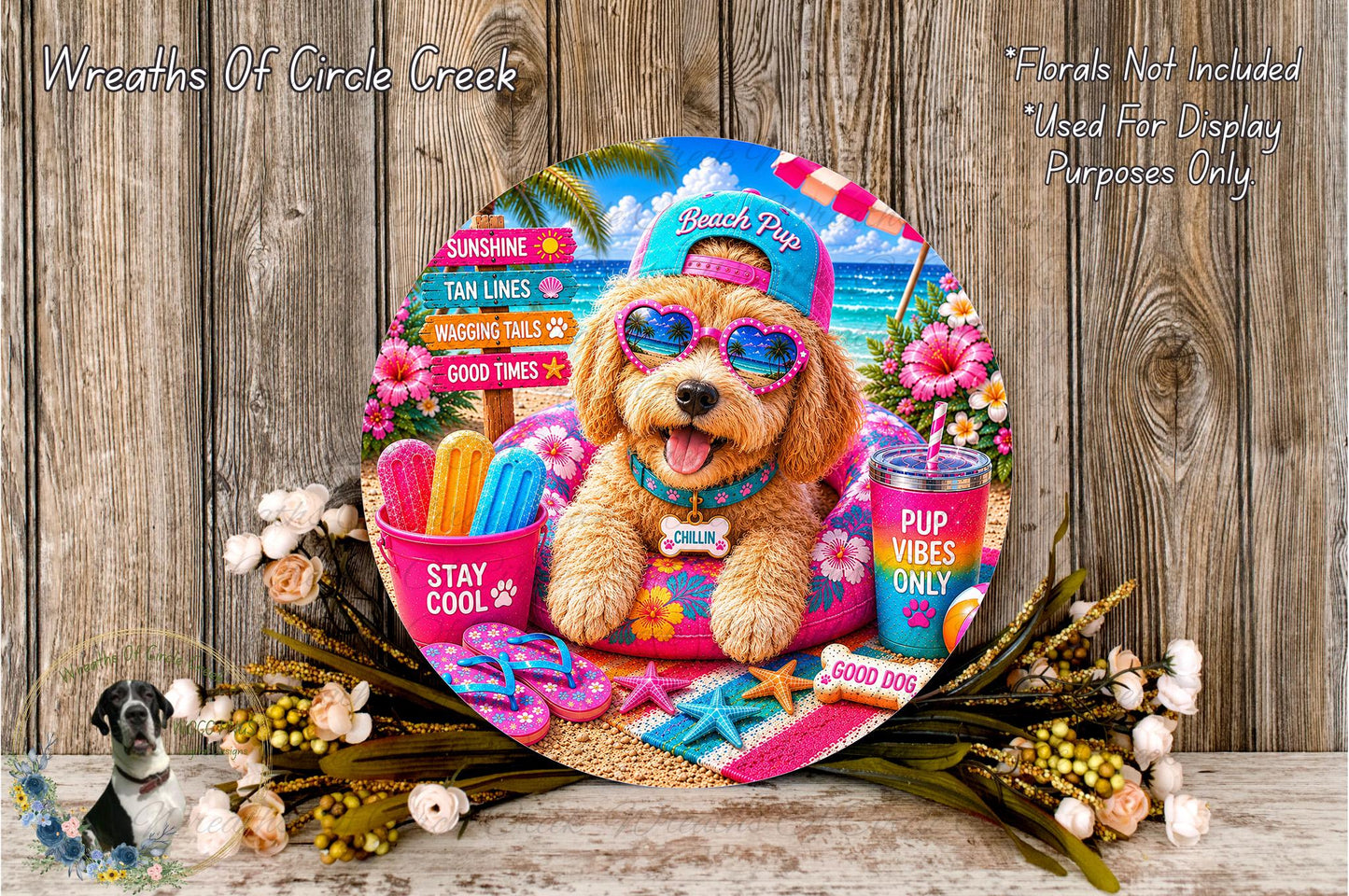 A colorful and whimsical wreath featuring a dog wearing sunglasses and beach-themed accessories, surrounded by beach-related items such as a beach ball, sunglasses, and a cup with a straw.