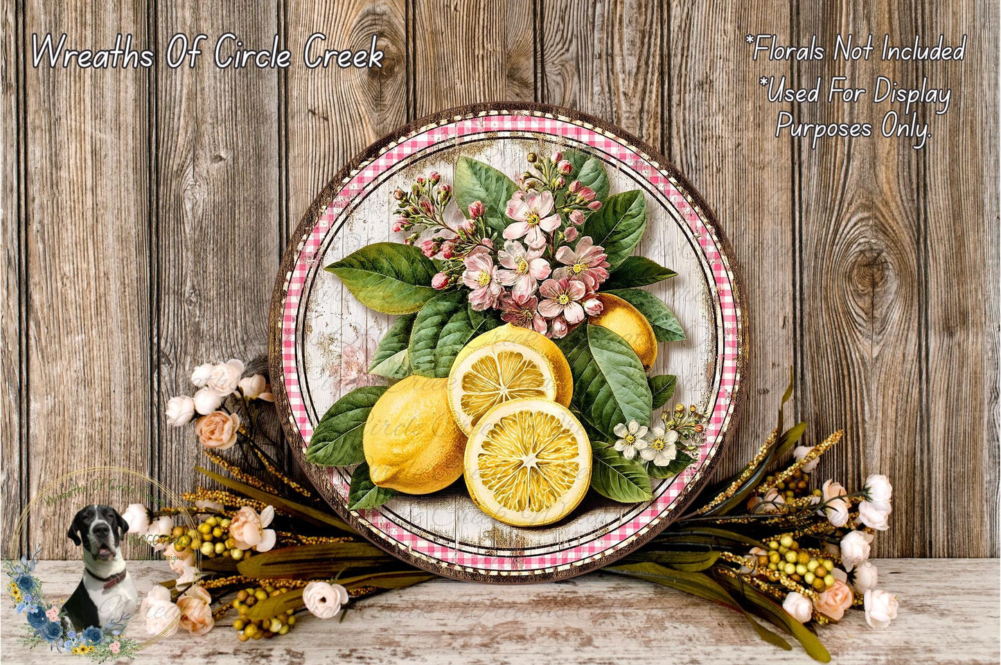 A decorative plate with a floral arrangement of lemons and flowers, placed on a wooden surface.