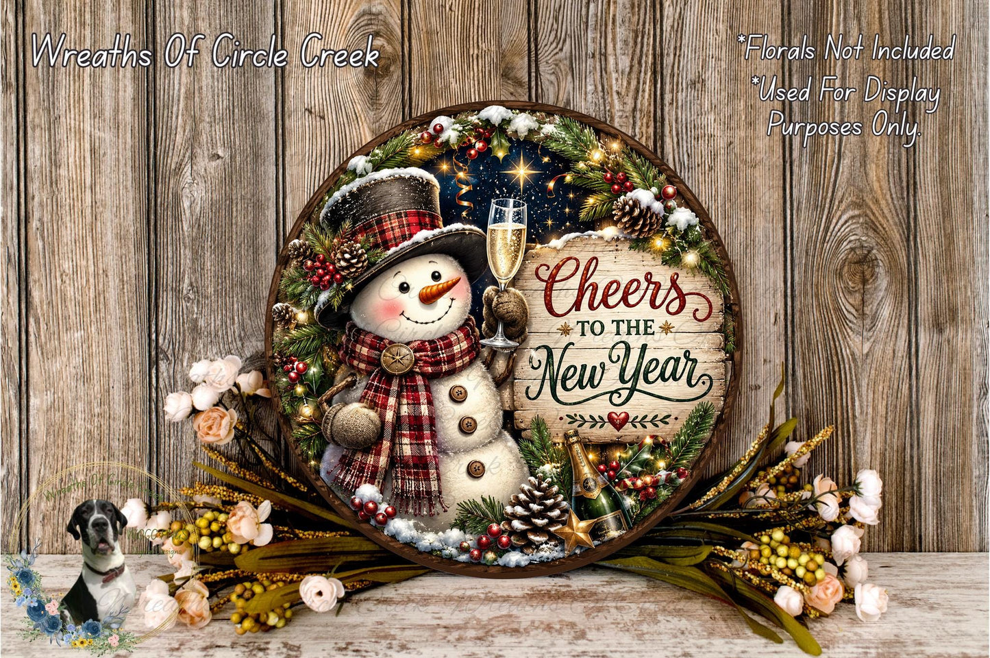 A snowman holding a champagne glass and surrounded by a wreath of Christmas decorations, including pine cones, berries, and flowers, with the text "Cheers to the New Year" displayed on the wreath.