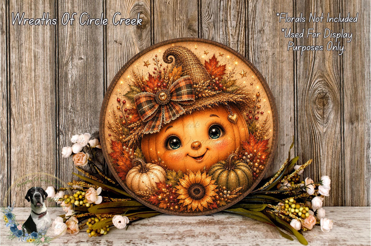 A round wooden plaque with a painted pumpkin face and autumn decorations, including flowers and leaves, is displayed on a wooden surface.