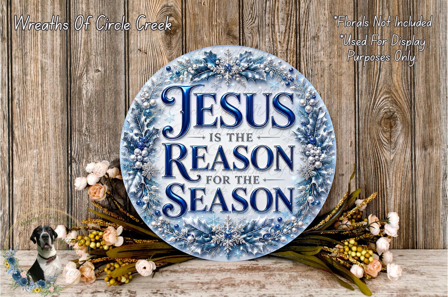 a circular sign with the text "JESUS IS THE REASON FOR THE SEASON" surrounded by a wreath of flowers and greenery.