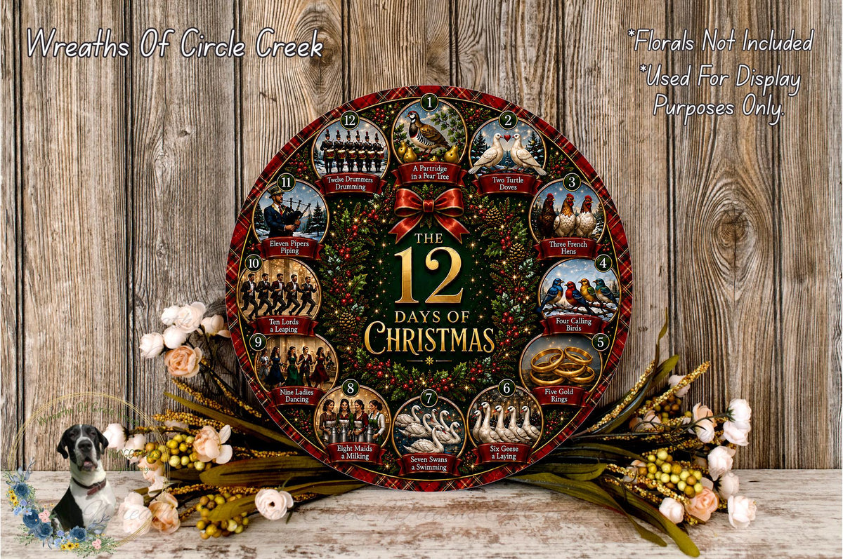 A decorative Christmas wreath with the text "The 12 Days of Christmas" displayed prominently. The wreath is surrounded by flowers and placed on a wooden surface.