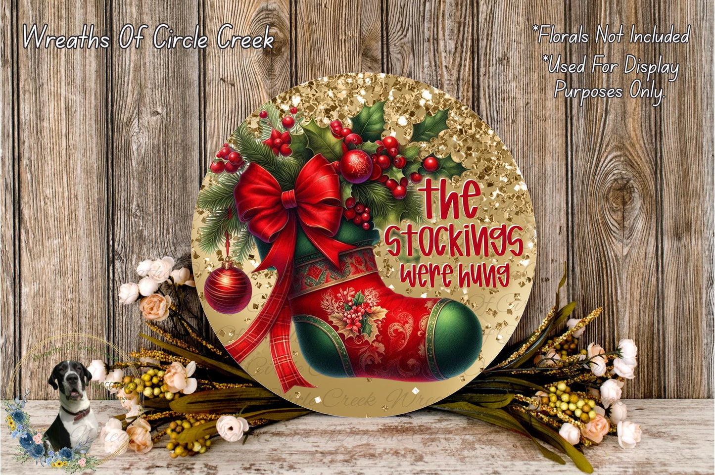 a festive Christmas-themed decoration with a red stocking and a bow, surrounded by flowers and greenery. The text "The stockings were hung" is displayed on the decoration, indicating that it is a Christmas stocking-related item.
