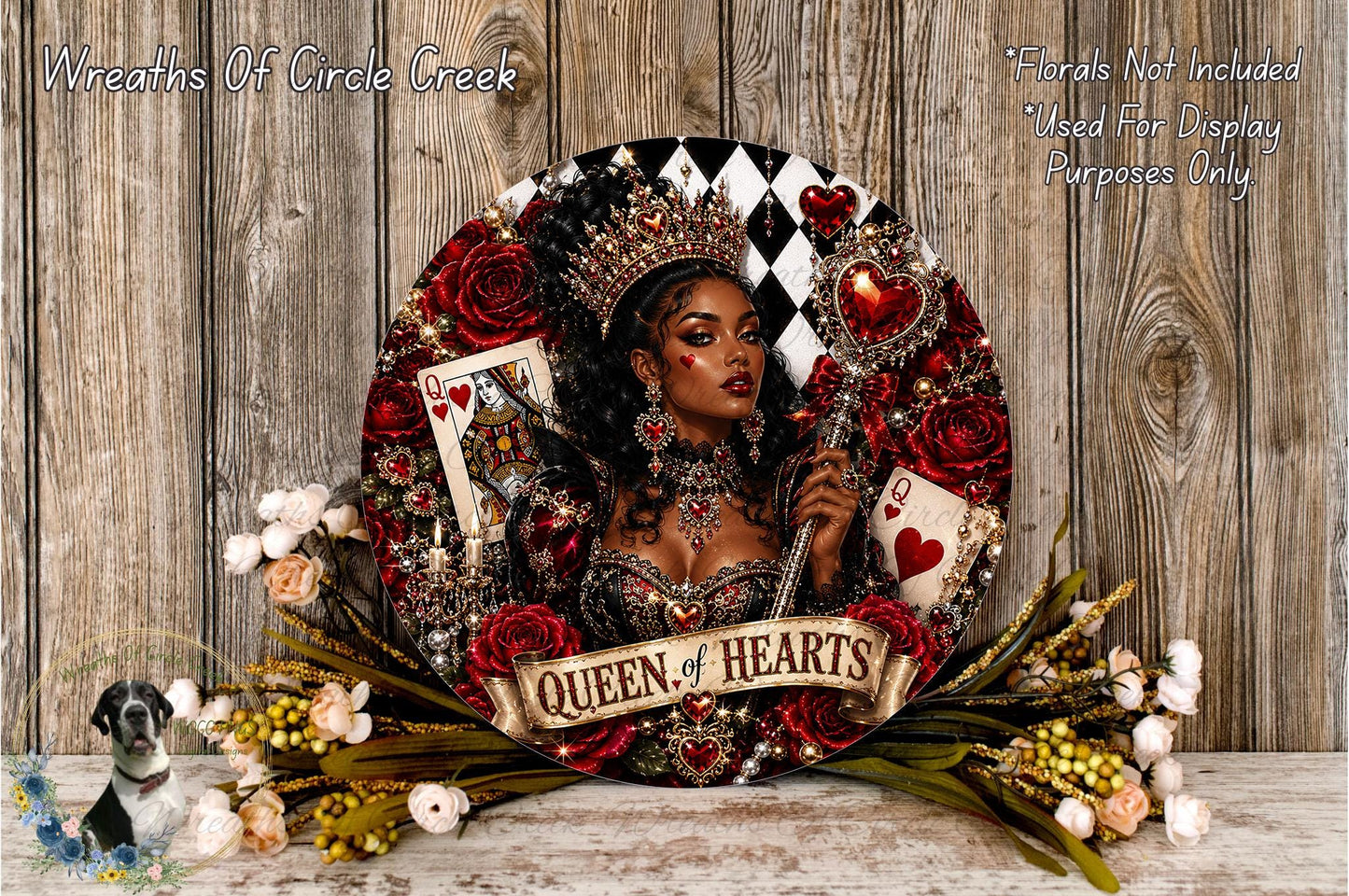 A decorative wreath featuring a woman wearing a crown and holding a deck of playing cards, surrounded by red roses and greenery.