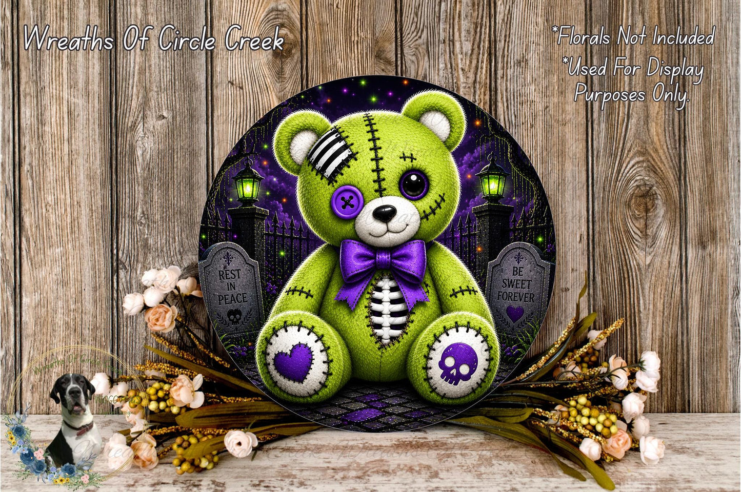 A green teddy bear with purple accents and a skull-like design on its hands and feet, surrounded by flowers and a spooky graveyard scene.