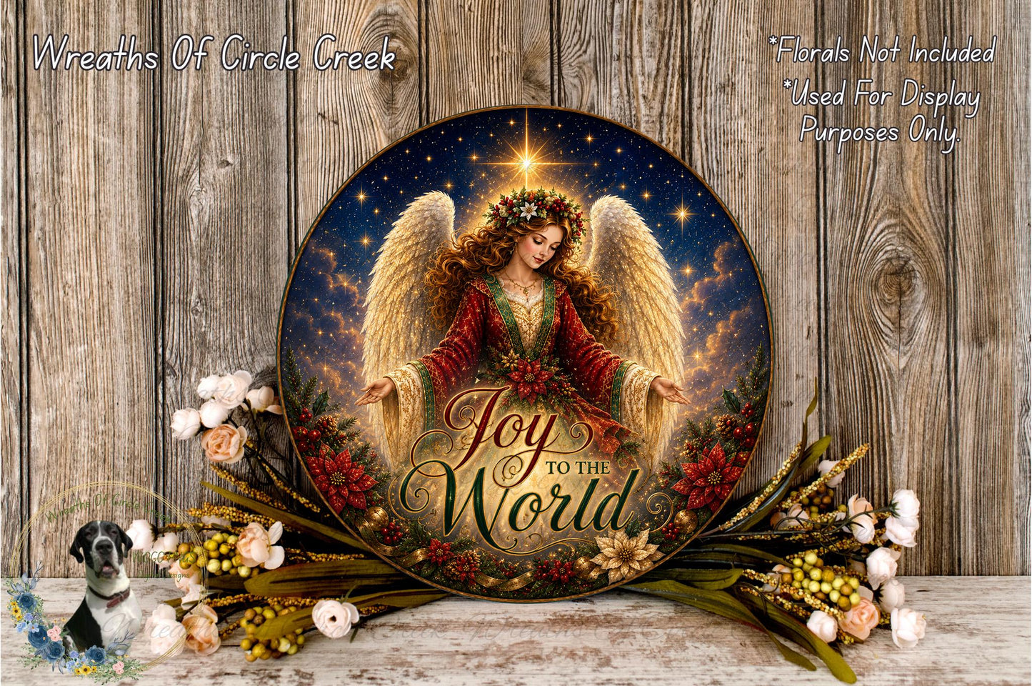 a round, decorative plate with a painting of an angel surrounded by flowers and greenery. The plate has the text "Joy to the World" written on it.