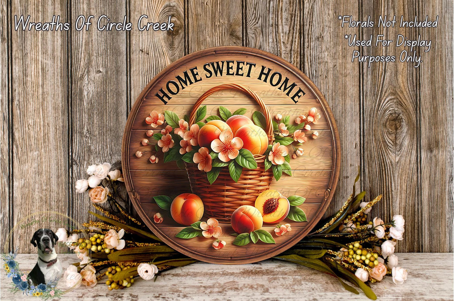 a wooden sign with a basket of peaches and flowers, surrounded by a wreath of flowers and leaves, all set against a wooden background.