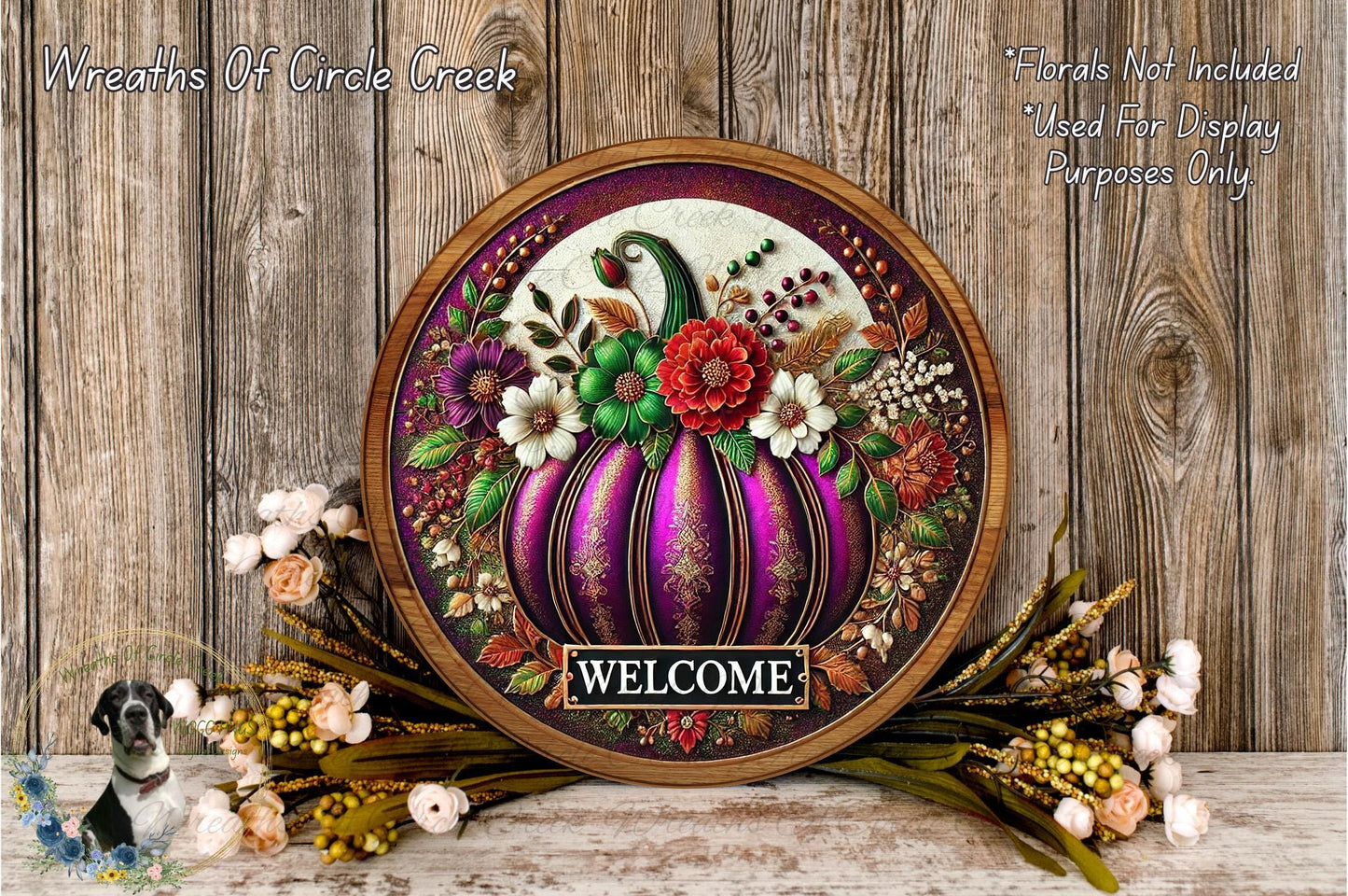 a decorative wreath with a large purple pumpkin at the center, surrounded by various fall-themed elements such as flowers, leaves, and a welcome sign.