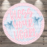 The image is a circular design with a pink and blue color scheme, featuring the text "Blush your heart" written in a decorative font.
