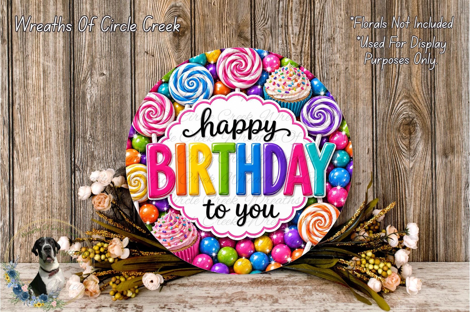 A colorful birthday wreath with the text "Happy Birthday to you" surrounded by various sweets and decorations, including lollipops, cupcakes, and candy.