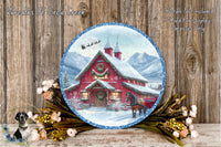 A round, decorative plate featuring a winter scene with a red barn, a horse, and snow-covered mountains in the background. The plate is surrounded by a wreath of flowers and greenery, and the text "Wreaths Of Circle Creek" and "Flowers Not Included Used For Display Purposes Only" is visible.