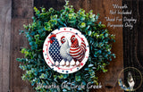 a wreath made of green foliage and decorated with three chickens, including a rooster, arranged around a circular design with stars and stripes.