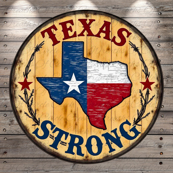 A circular wooden sign with the text "TEXAS STRONG" and a map of the state of Texas, surrounded by a wreath of stars.