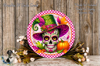 A decorative plate featuring a colorful design of a skull wearing a hat, surrounded by flowers and a pumpkin, against a wooden background.