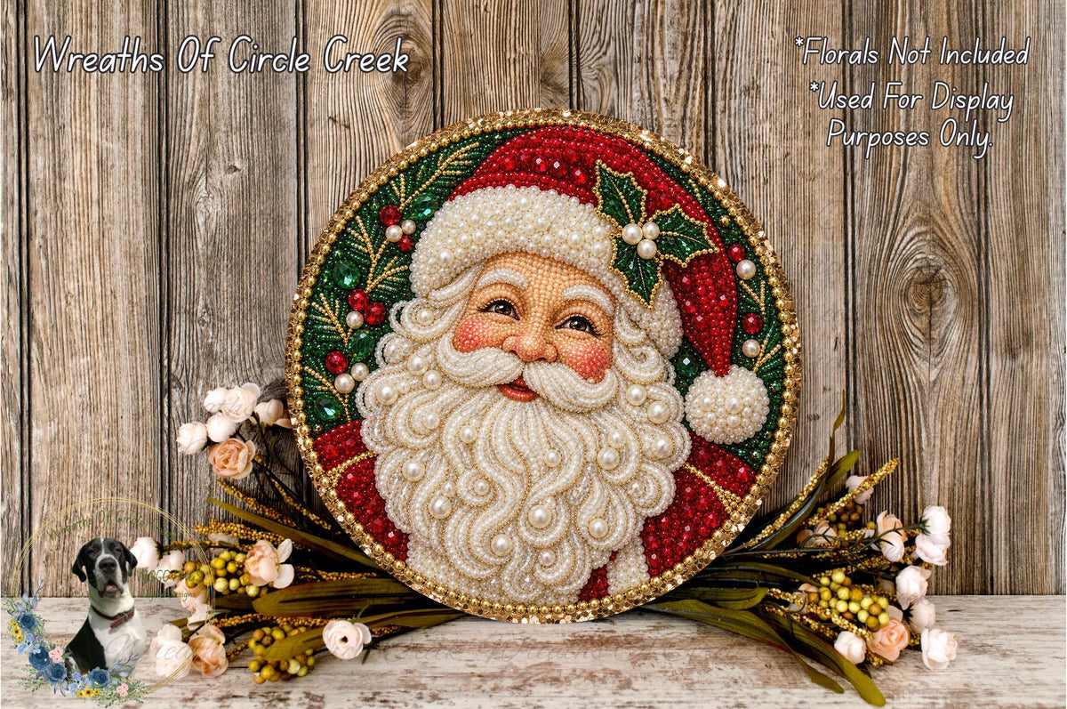 A decorative wreath featuring a Santa Claus face, surrounded by flowers and placed on a wooden surface.