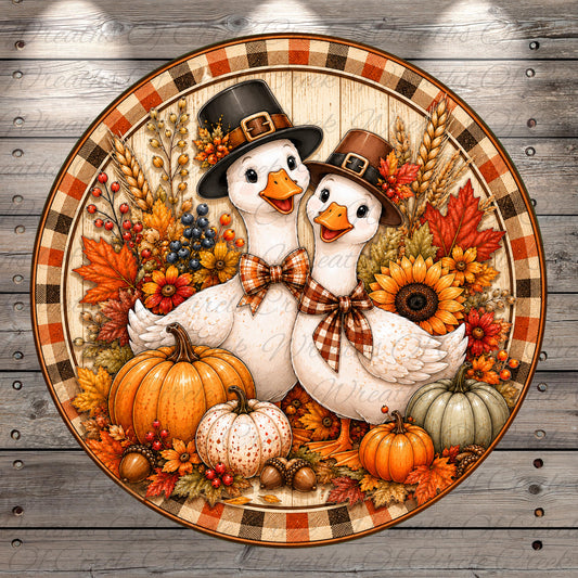 A decorative plate featuring two white geese wearing Thanksgiving hats, surrounded by autumn-themed elements such as pumpkins, sunflowers, and acorns.