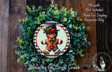 A wreath made of green foliage and featuring a gingerbread man figure, with a caption indicating that the wreath is not included in a display and is used for purposes only.