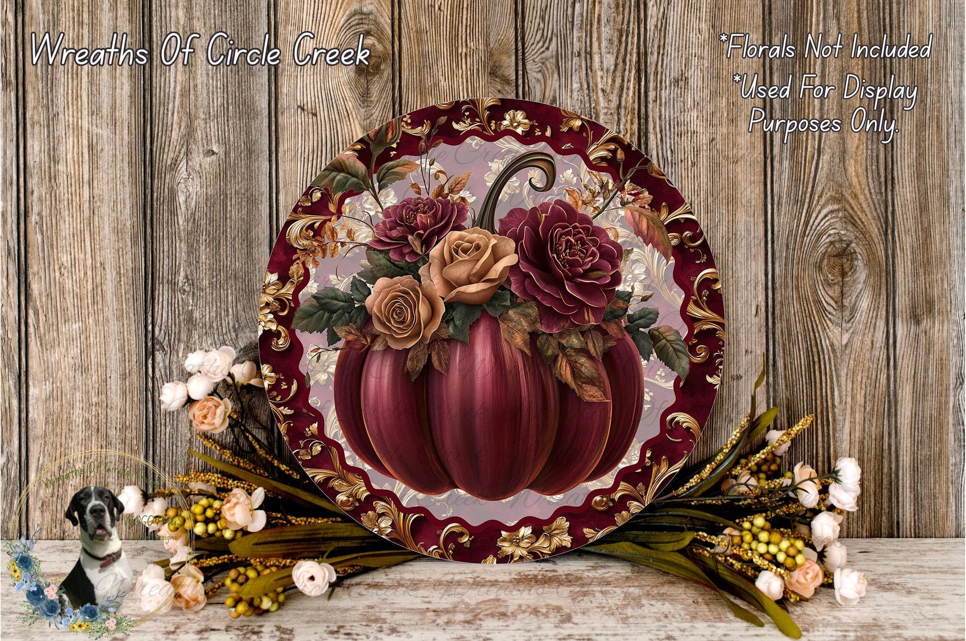 a decorative arrangement of a large, ornate pumpkin with a floral design, surrounded by various fall-themed elements such as flowers and foliage.