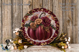 a decorative arrangement of a large, ornate pumpkin with a floral design, surrounded by various fall-themed elements such as flowers and foliage.