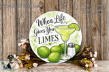 a decorative sign with the text "When Life Gives You Limes" and an illustration of a margarita glass with a lime slice. The sign is surrounded by a wreath of green limes and a salt shaker, and there is a small dog in the background.