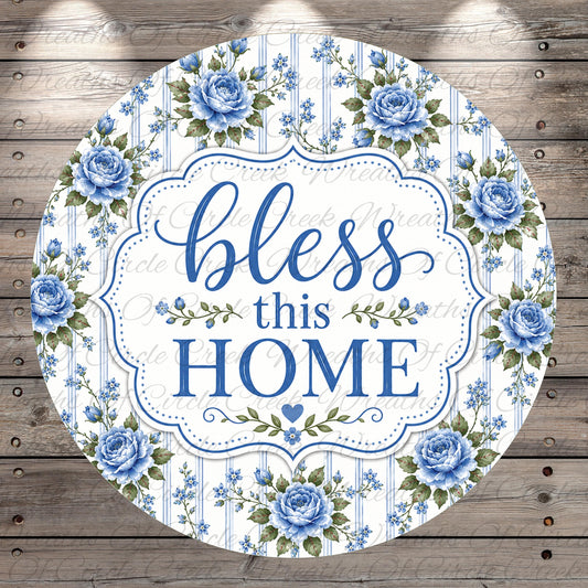 A round sign with a floral border and the text "bless this home" in blue and white.