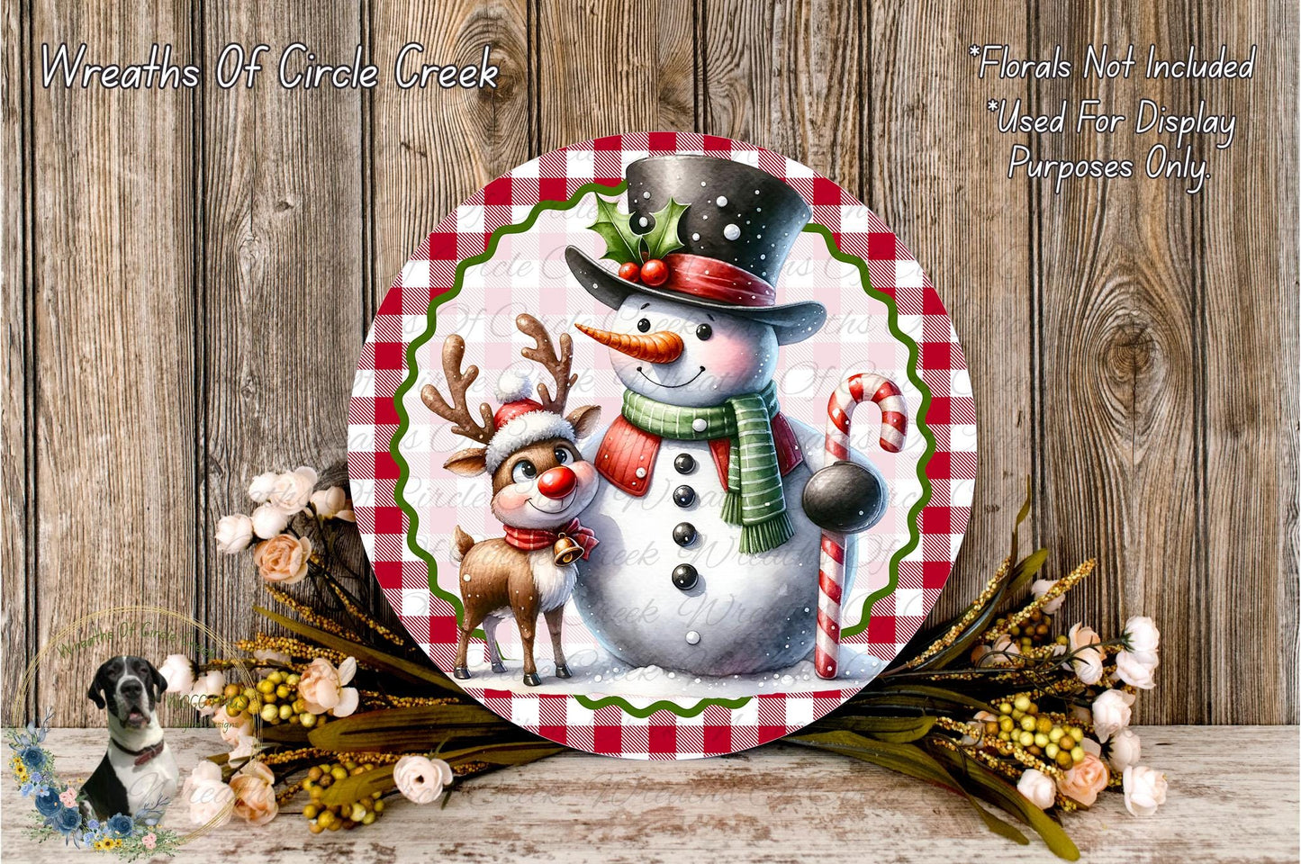 A snowman and a reindeer are depicted on a festive wreath, surrounded by a floral arrangement and a wooden background.