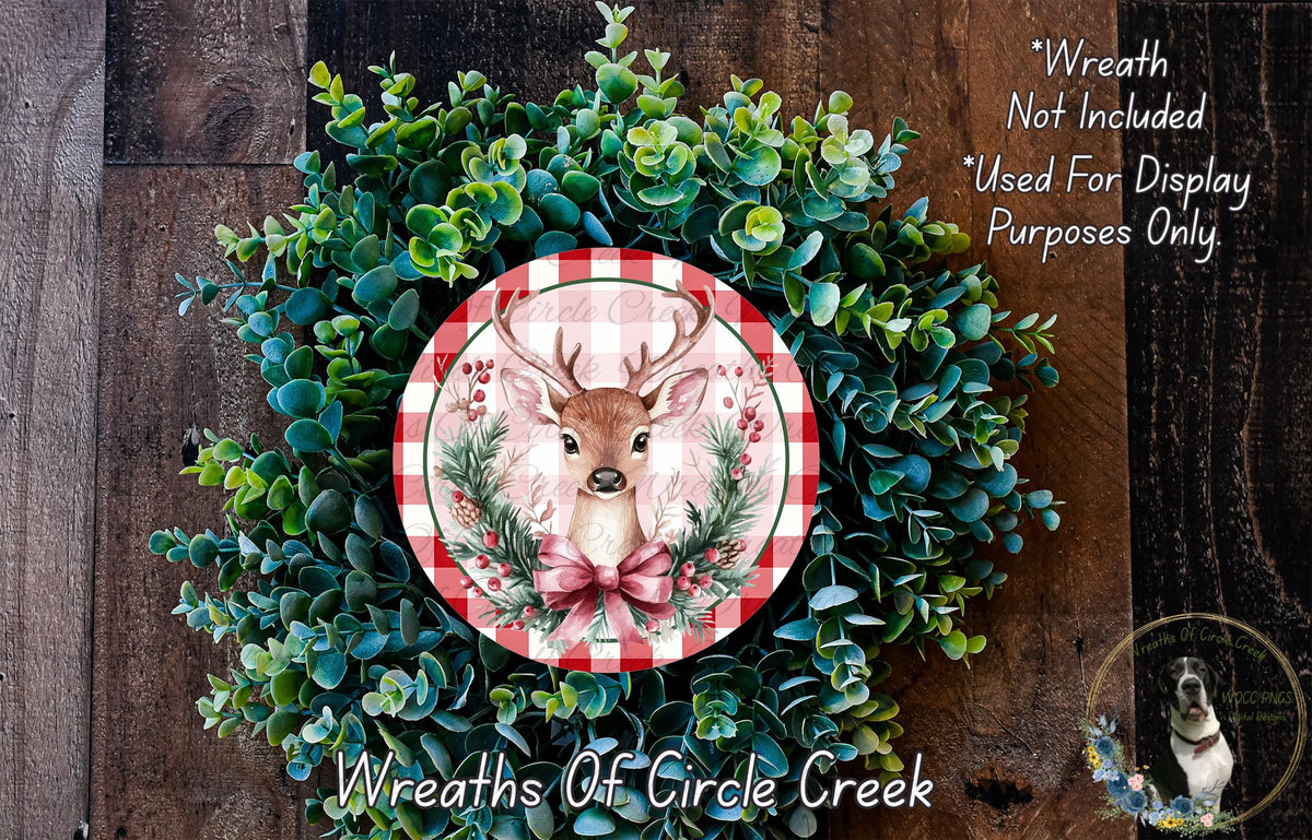 A wreath made of green foliage and a red and white checkered plate featuring a deer head, with the text "Wreath Not Included * Used For Display Purposes Only" and "Wreaths Of Circle Creek" below the image.