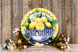 a decorative sign with a yellow and blue checkered pattern, surrounded by a variety of flowers and fruits, including lemons, blueberries, and peaches. The sign prominently displays the word "Welcome" in a stylized font.
