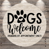 a circular sign with the text "Dogs Welcome (Humans by Appointment Only)" written on it.