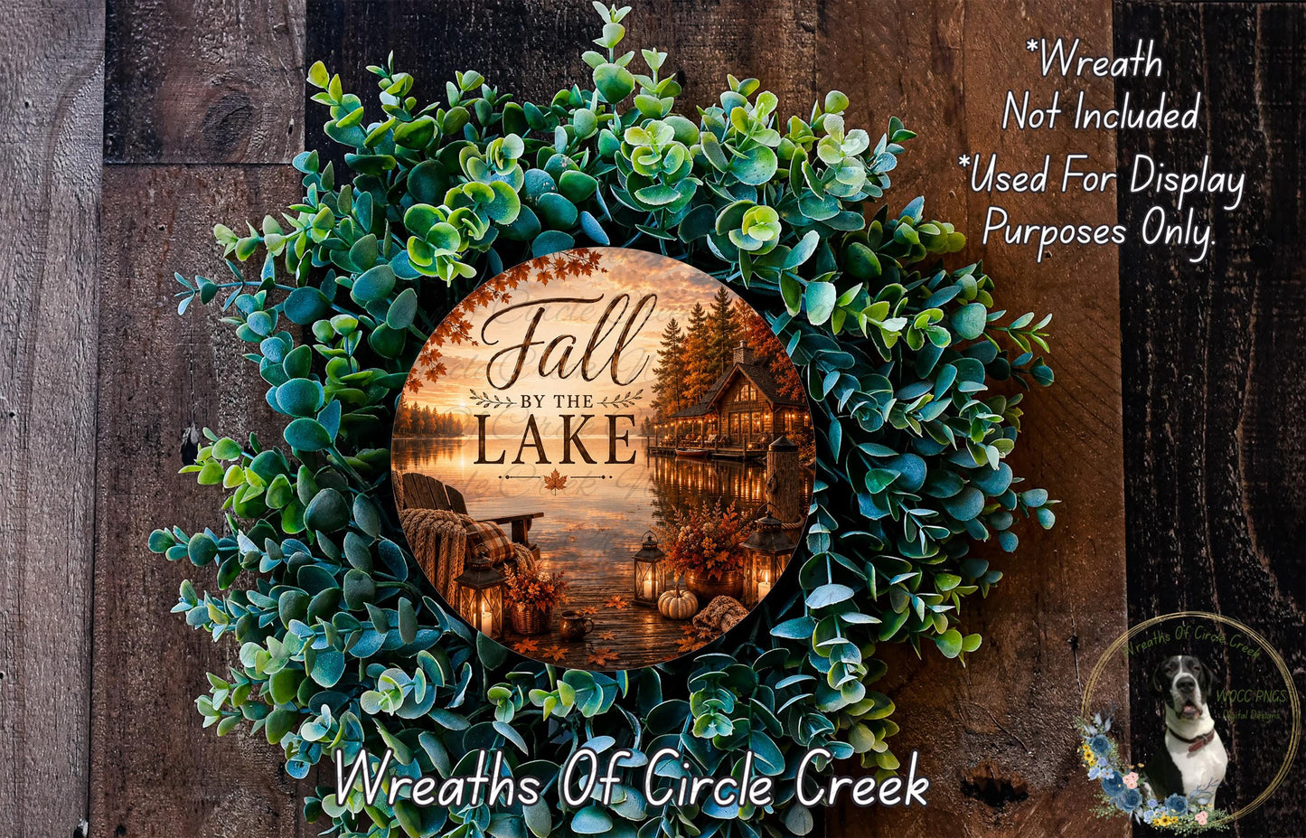 a wreath made of green leaves and a circular sign with a scenic image of a lake and fall foliage.
