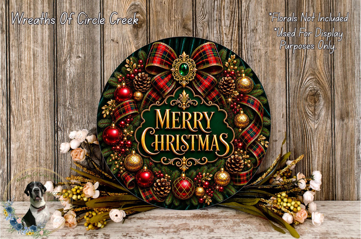 A festive Christmas wreath with a green background, red and gold plaid ribbons, and various ornaments, including red and gold balls, pine cones, and white flowers, is displayed on a wooden surface.