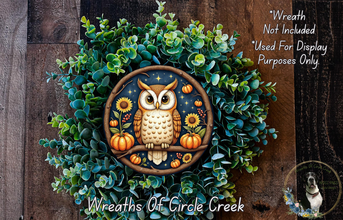 A wreath featuring an owl surrounded by autumnal elements such as pumpkins, sunflowers, and pine cones, set against a backdrop of greenery.
