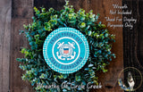 A wreath made of green leaves and a blue and white circular emblem, with the text "Proud PARENT OF A COAST GUARDMAN" and "Wreaths of Circle Creek" displayed on it.