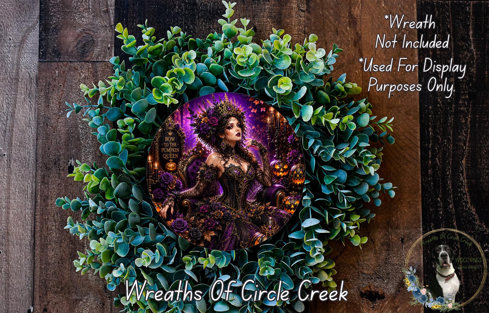 a wreath with a woman in a purple dress and a crown, surrounded by green leaves and flowers. The wreath is displayed on a wooden surface, and there is a small dog in the bottom right corner of the image.