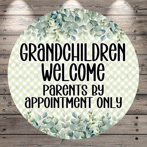 A circular sign with a green leafy pattern and text that reads "GRANDCHILDREN WELCOME PARENTS BY APPOINTMENT ONLY".