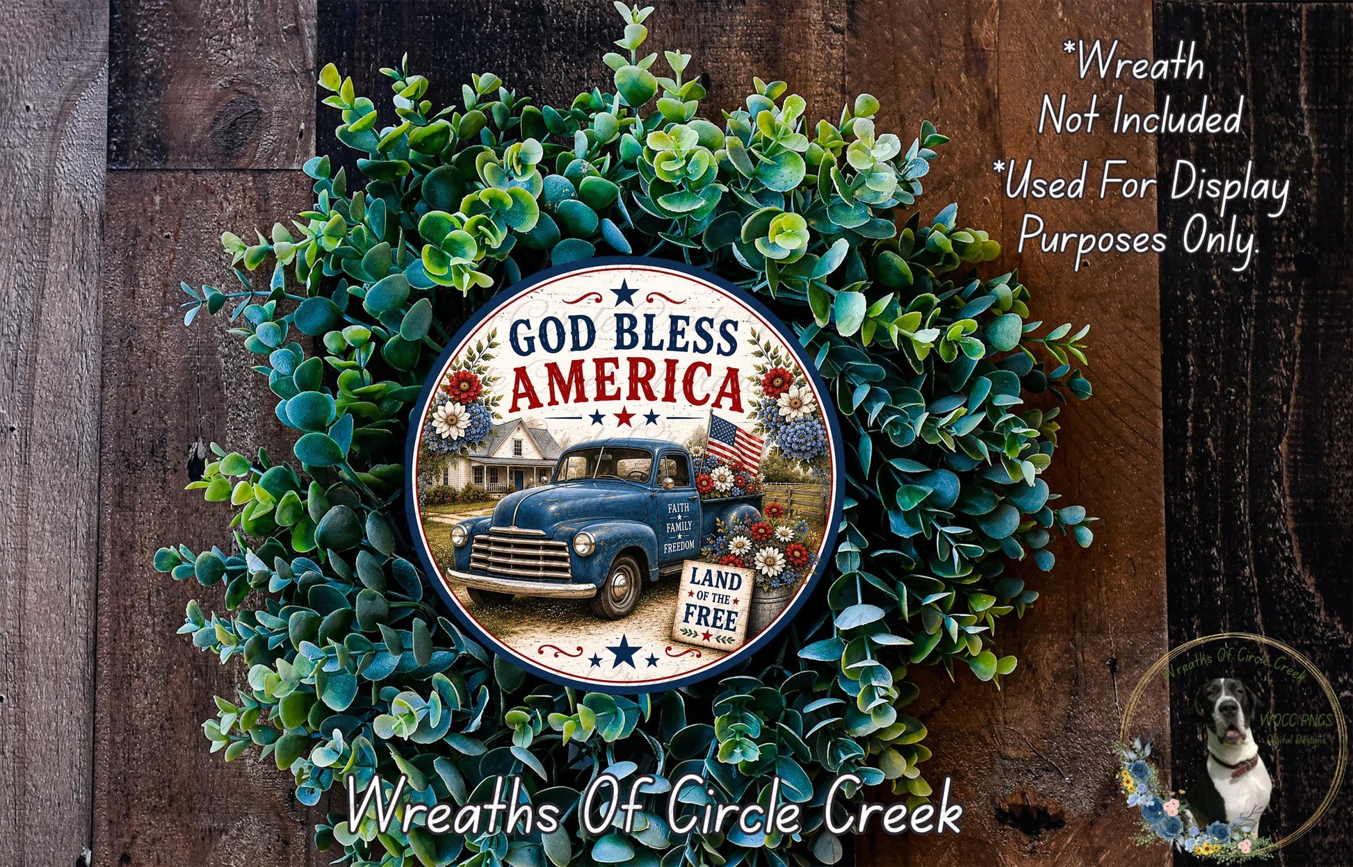 A wreath made of green leaves and a blue truck with an American flag design, featuring the text "God Bless America" and "Land of the Free".