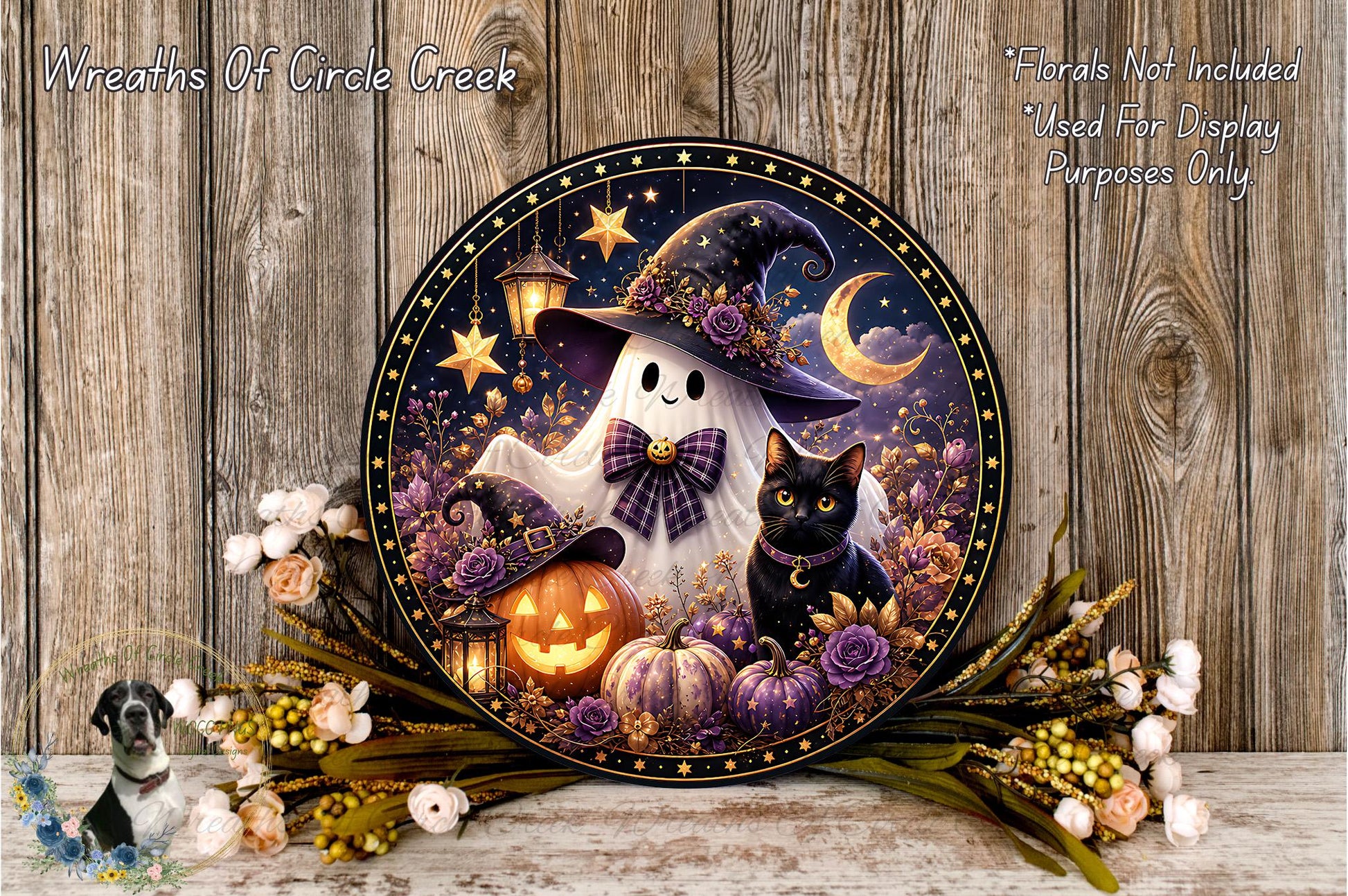 A Halloween-themed wreath featuring a ghost, a witch, a cat, pumpkins, and flowers, set against a wooden background.