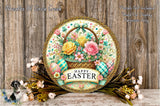 A decorative Easter wreath with a basket of flowers, surrounded by a variety of colorful flowers and greenery, placed on a wooden surface.