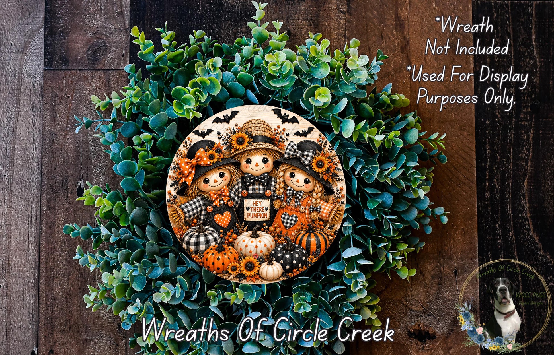 a wreath with a group of three scarecrow dolls, each holding a sign that says "Hey Pumpkin". The wreath is made of green foliage and has a wooden background.
