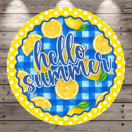 A circular sign with the text "Hello summer" written on it, surrounded by lemon slices and a blue and white checkered pattern.