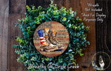 a wreath made of green foliage and a circular design with an American flag pattern, along with a pair of boots and a patriotic message.