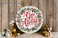 a round wooden sign with the text "Go Away" written on it, surrounded by a wreath of greenery and flowers. The sign is placed on a wooden surface, and there are additional floral arrangements nearby.