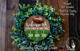a wreath made of green foliage and a football, with a welcome sign that reads "Welcome ish, come back at half-time 30 40 50".