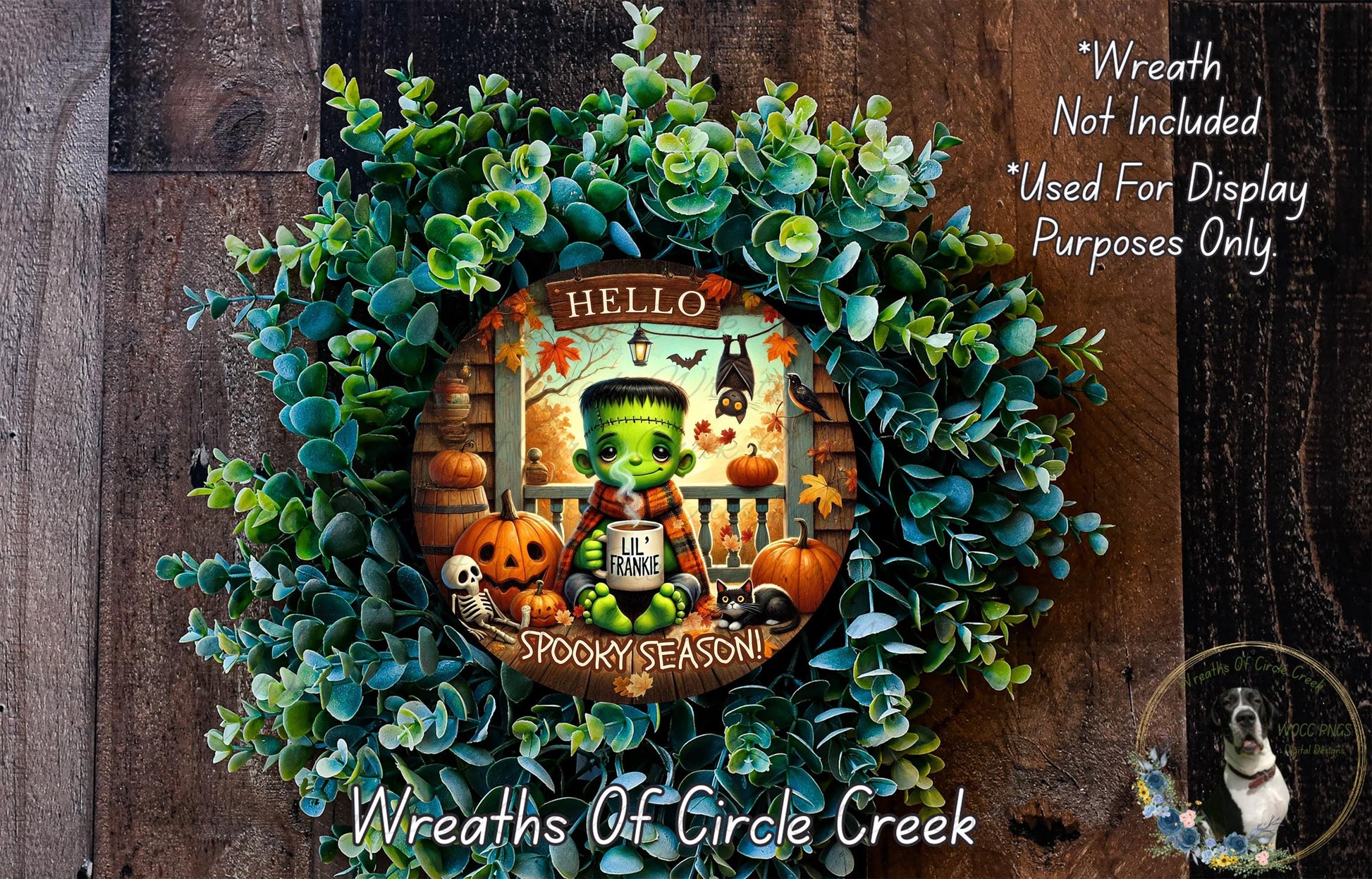 A wreath featuring a spooky green monster with a friendly greeting, surrounded by autumn-themed decorations such as pumpkins and a skeleton.