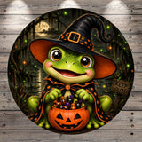 A cartoon frog wearing a witch's hat and holding a carved pumpkin, surrounded by a spooky Halloween scene with a full moon and misty forest.