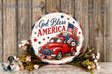 A circular sign with a red truck and American flags, surrounded by flowers, against a wooden background.