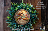 A wreath made of green leaves and flowers, featuring a cartoon cow wearing sunglasses and holding a sign that says "Hello Summer".