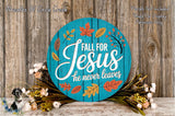 a blue circular sign with the text "FALL FOR JESUS he never leaves" surrounded by autumn leaves and flowers. The sign is placed on a wooden surface, and there are additional floral arrangements in the background.